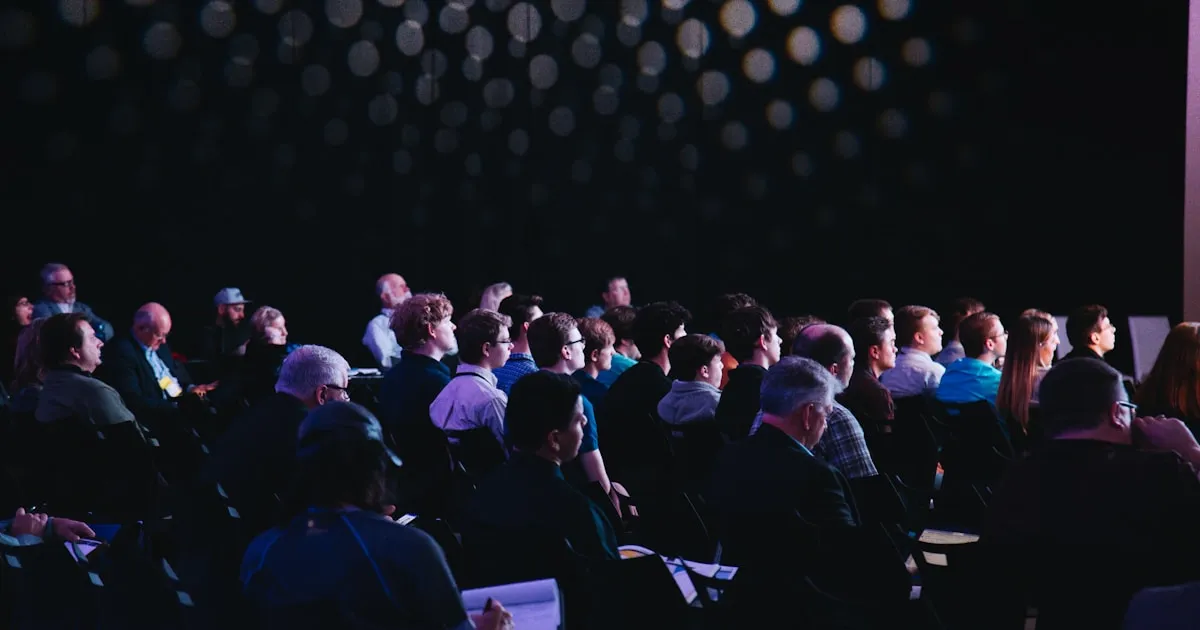 Busy trade show floor with exhibitor booths of various sizes