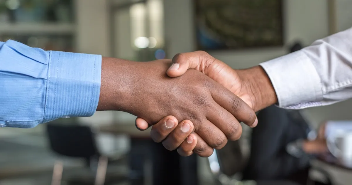 Business handshake representing successful cost negotiation